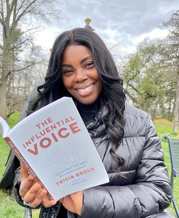 Keiya Rayne holding the influential voice book